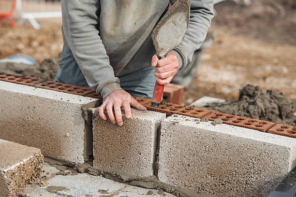 istock Mason works with bricks at a construction site during daytime to build a sturdy wall using a trowel and precision techniques 2234104167