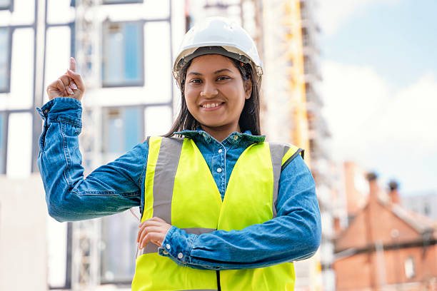 istock Construction worker smiling at a building site during the day, showcasing confidence and teamwork in the construction industry 2234104501