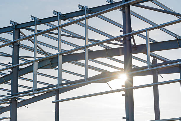 istock Sunlight shining through the steel frame of a modern building under construction during a clear day in an urban setting 2234104706