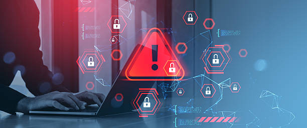 istock Cybersecurity breach warning concept with red alert symbols and padlocks over person typing on laptop in digital environment background. 2234104893