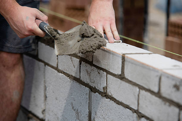 istock Skilled worker lays bricks in new construction project at building site during daytime hours 2234105724
