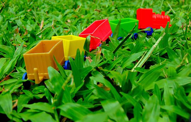A close-up view of the colorful wagon toys for kids on the green grass.