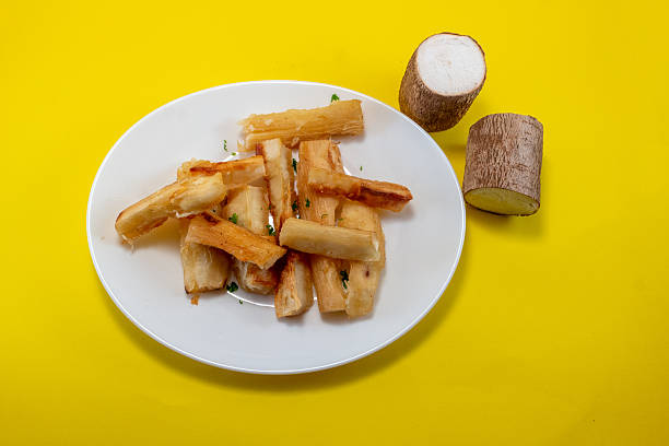 Cassava Fries and Fresh Cassava Root on Yellow Background