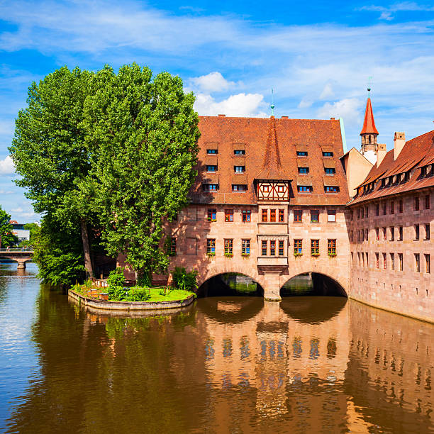 Heilig Geist Spital or Holy Spirit Hospital near Pegnitz river in Nuremberg old town. Nuremberg is the second largest city of Bavaria state in Germany.