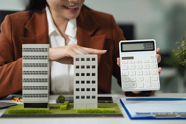 istock Home loan, officer uses a calculator with a house plan. 2234108609