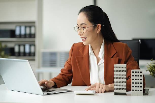 istock Home loan, officer uses a calculator with a house plan. 2234108611