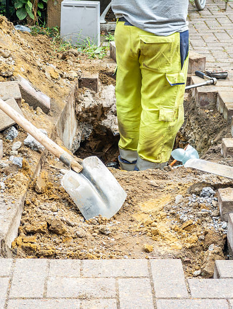 istock Workers wearing yellow work trousers are digging a hole to disconnect utilities such as gas and electricity. Shutting of gas and electricity connections from the net. 2234108694