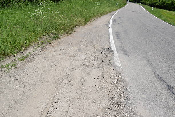 istock dirt lane at a road 2234109840
