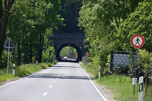 istock road through a tunnel with no pedestrian sign 2234110796
