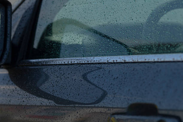 istock Raindrops falling on the surface of a car, creating remarkable reflections 2234111591