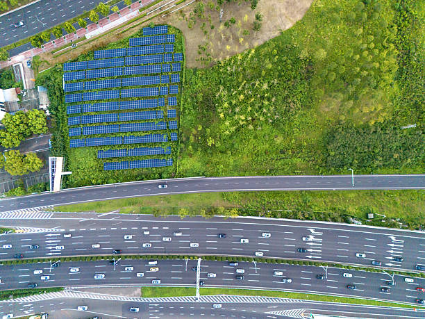 istock Solar panels on the grass in the city at sunset 2234111983