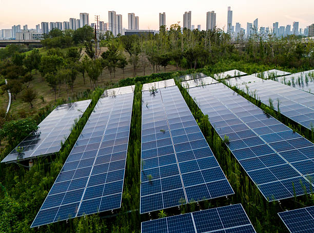 istock Solar panels on the grass in the city at sunset 2234112005
