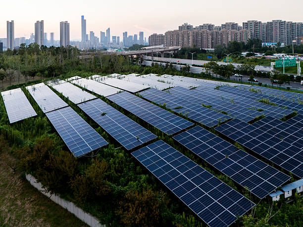 istock Solar panels on the grass in the city at sunset 2234112007