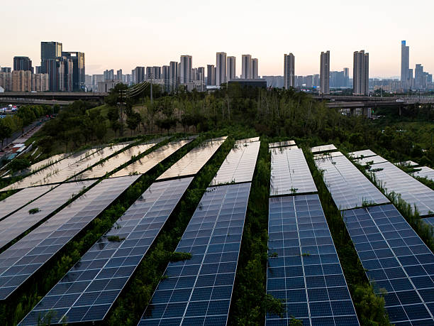 istock Solar panels on the grass in the city at sunset 2234112012