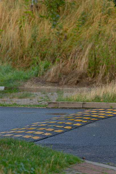 istock Road Speed Bump with Yellow Markings in Natural Setting 2234112750