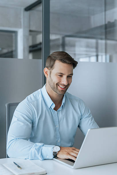 istock European businessman ceo specialist using computer technology app for work online. Young professional specialist latin hispanic businessman working on laptop pc sitting at desk in office. Vertical 2234112777