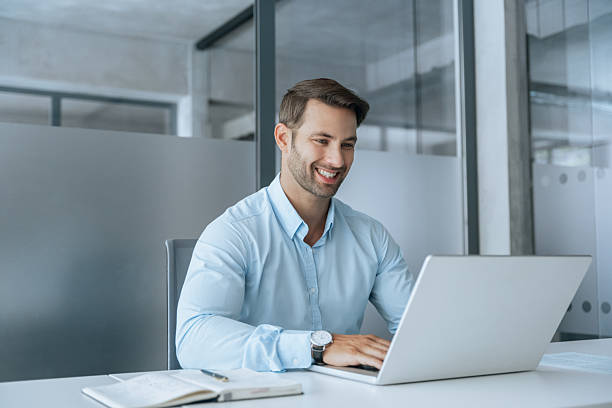 istock European businessman ceo specialist using computer technology app for work online. Young professional specialist latin hispanic businessman working on laptop pc sitting at desk in modern office space 2234112784