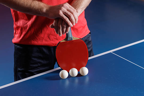 istock Table tennis paddle with balls on blue table serve preparation closeup 2234114063