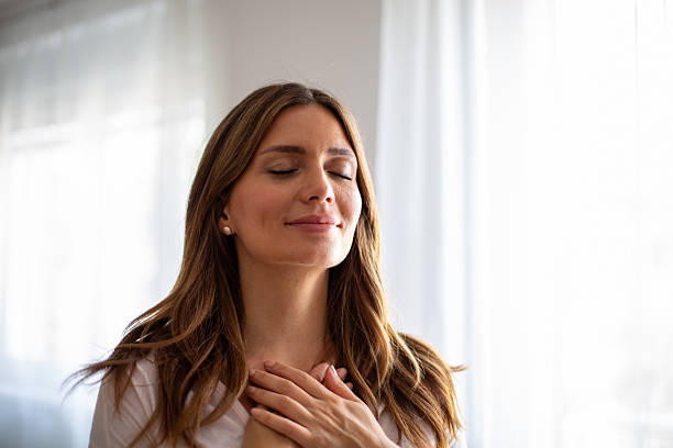 Serene woman practicing mindfulness with gratitude and deep breathing