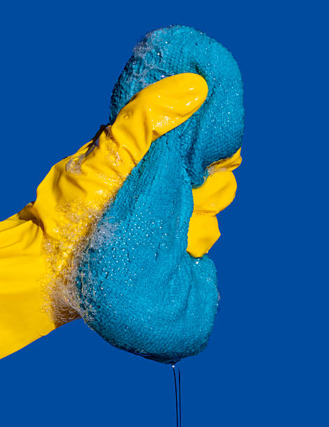 istock Hand in Rubber Glove Squeezing Soapy Sponge – Cleaning and Hygiene Concept. 2234116429