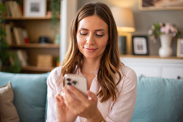 istock Young woman using smartphone at home: browsing internet and social media 2234117435