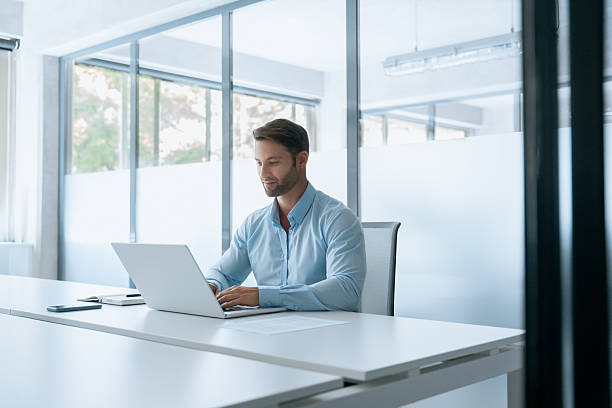 istock European businessman entrepreneur using computer technology app for work online. Young professional specialist latin hispanic business man working on laptop pc sitting at desk in office. Copy space 2234118485