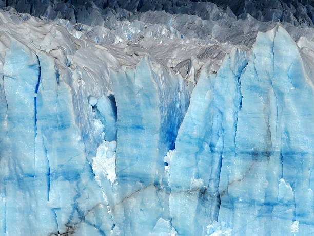 Stunning view of a glacier's ice formations showcasing intricate layers and natural textures, capturing the unique hues and vitality of frozen water in an ethereal display of nature's power and beauty.