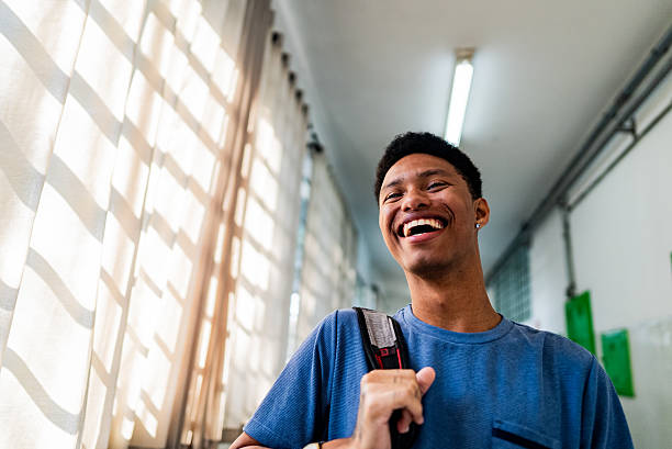 Smiling young student contemplating in school