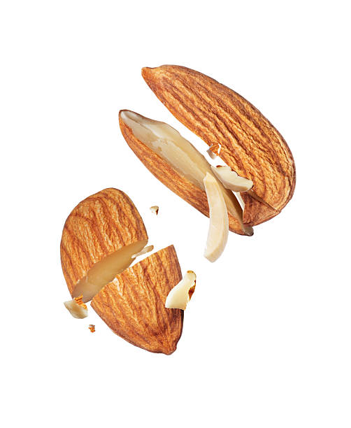 istock Two crushed almonds in the air close-up isolated on white background 2234120288