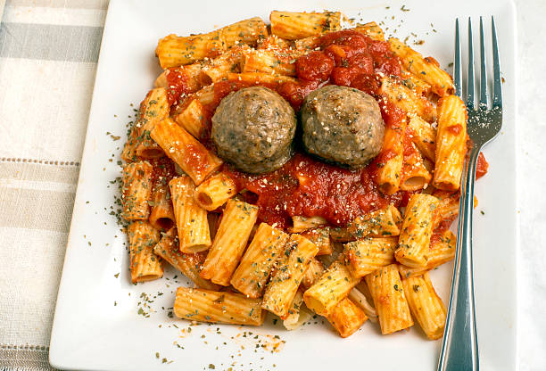 rigatoni top with herbs  served with meatballs and pasta sauce