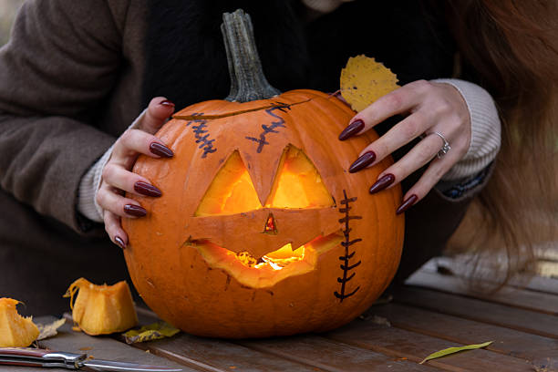 istock Woman and Halloween pumpkin 2234121746