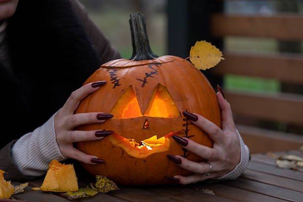 istock Woman and Halloween pumpkin 2234121747