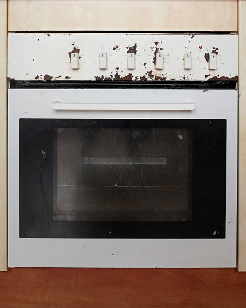 istock Vintage kitchen oven with worn white exterior and peeling paint, featuring control knobs and a glass door, showcasing rustic charm and age in a domestic setting 2234125106