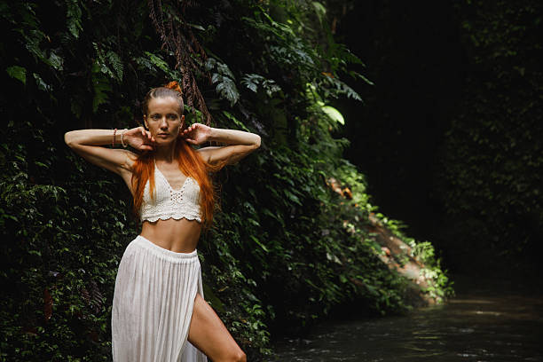 istock Confident woman posing in nature surrounded by lush green forest 2234126810
