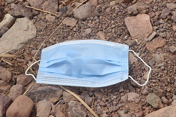 istock surgical mask lying on the ground 2234127652