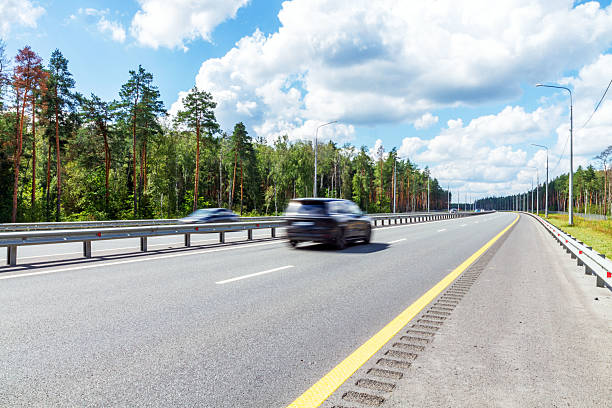 istock Highway with moving cars on a summer day 2234127786
