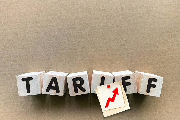 TARIFF word on toy block on paper background.