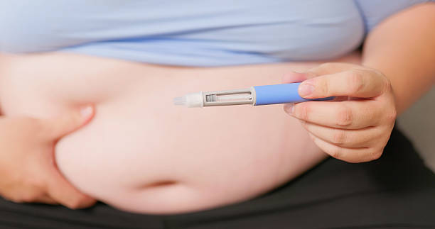 istock man injects medication into belly 2234129722