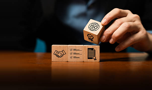 istock Hand stacking wooden blocks with quality, certification, and ISO icons, symbolizing business standards, process management, quality assurance, compliance, trusted partnership for sustainable growth. 2234131436