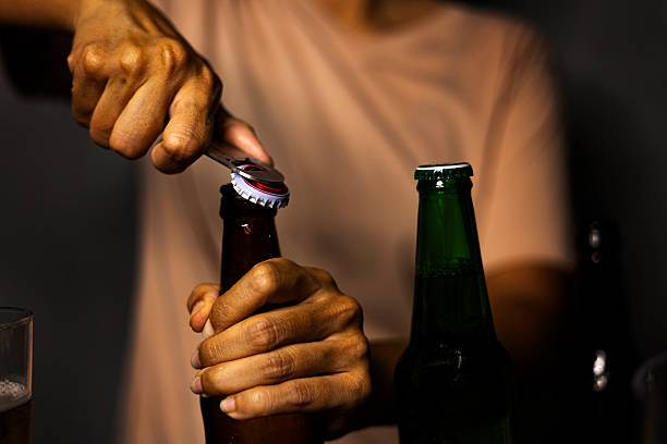 istock Woman Opening Beer Bottle With Opener 2234133542