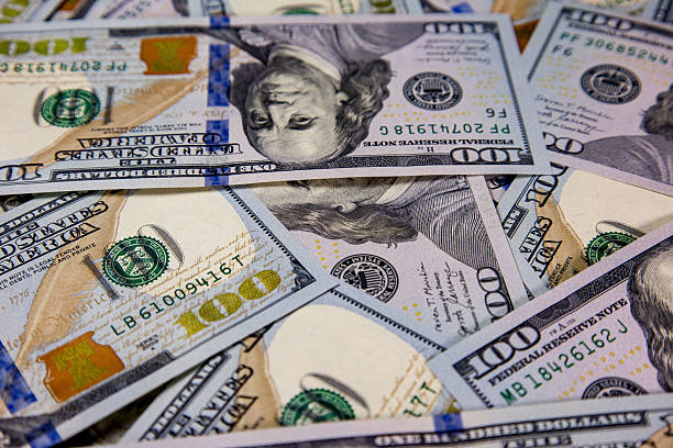 istock Various hundred dollar bills spread on a flat surface showcasing intricate designs and details in close proximity under natural lighting 2234134988
