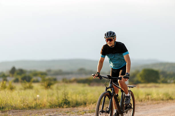 istock Man riding bicycle on a dirt trail 2234136253