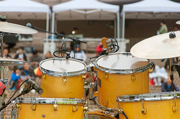 a gold drum kit on a stage in hong kong china with a blurred background.