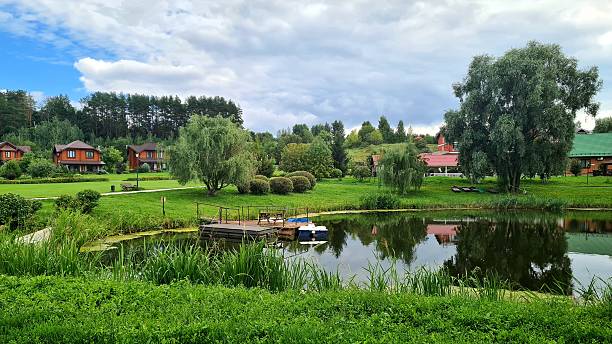 istock A small pond next to cottages and woods 2234140881