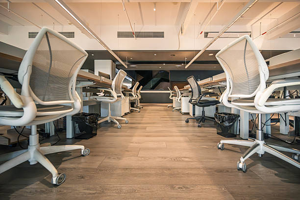 istock Modern Open-Plan Office Space with Ergonomic Chairs and Wooden Flooring 2234141559