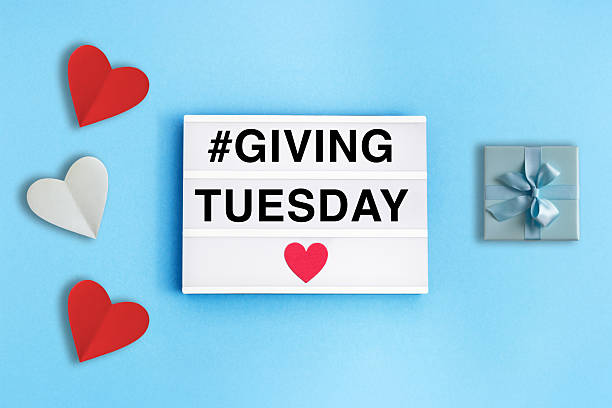 istock Giving Tuesday Concept with Lightbox Sign, Hearts, and Gift Box on Blue Background 2234142741
