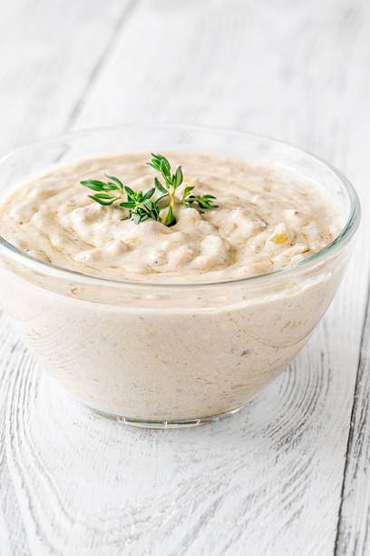 istock Creamy blue cheese sauce garnished with thyme in clear bowl on table 2234143448