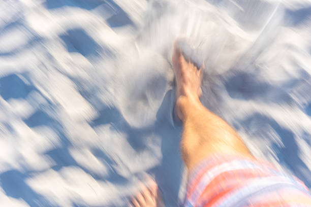 View of feet walking on a beach with motion blur