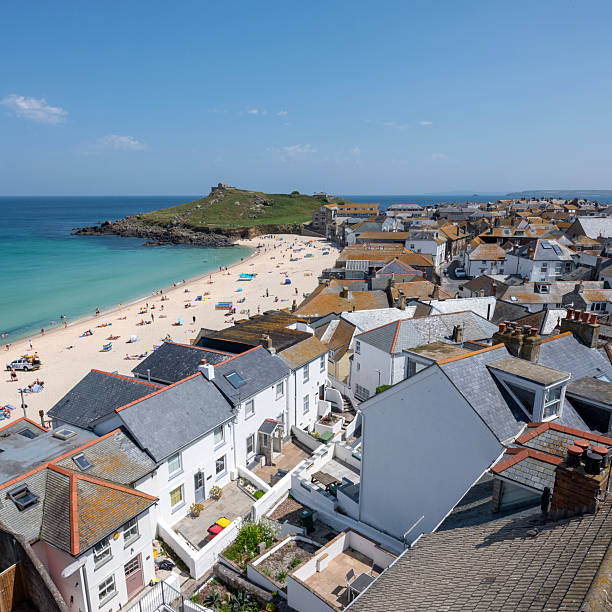 beach in st ives under blue spring sky in june full of people enjoying cornwall in england