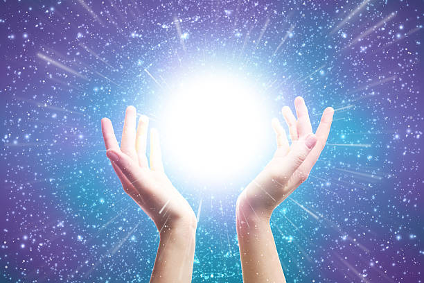 istock Hands Reaching Toward Glowing Light in Sparkling Galaxy Background Representing Energy and Healing 2234144447